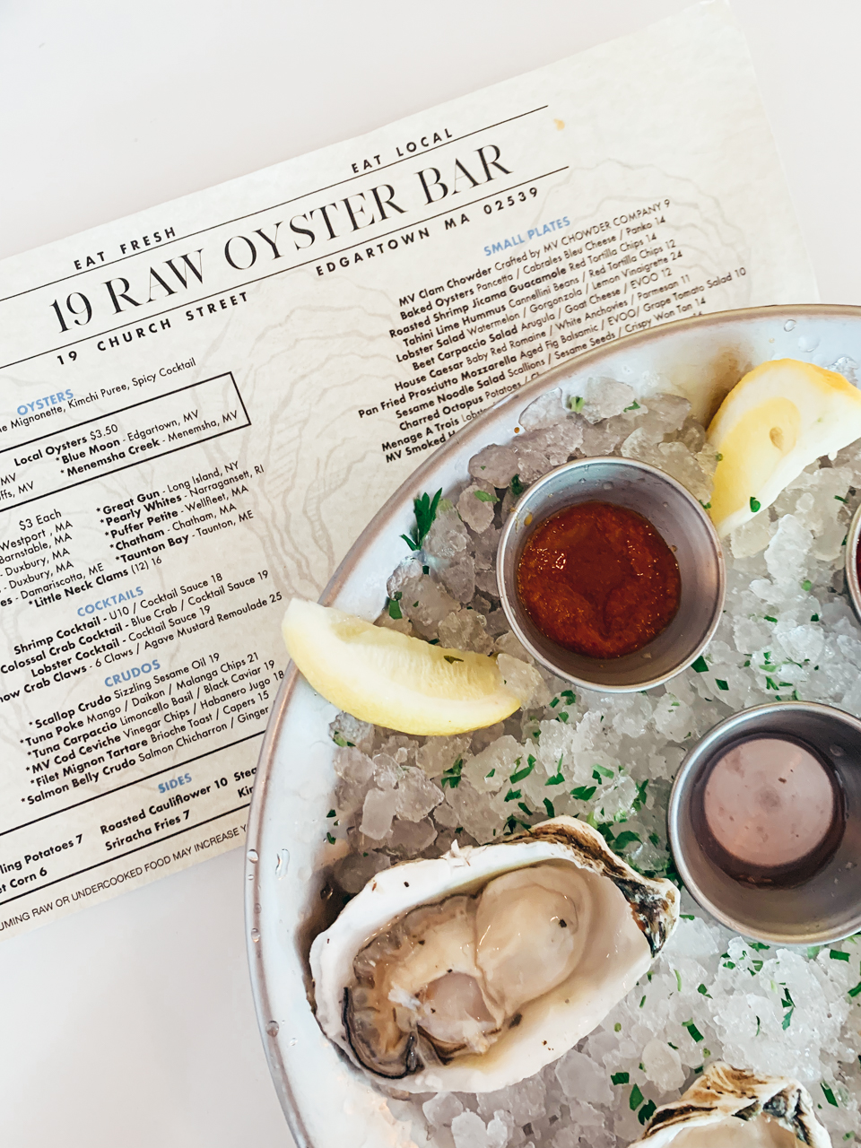 19 Raw Oyster Bar | New England Foodie Guide: Top 8 Restaurants in Martha's Vineyard You Must Try by popular New England Food Blogger, Shannon Shipman: image of a plate of oysters at 19 Raw Oyster Bar.