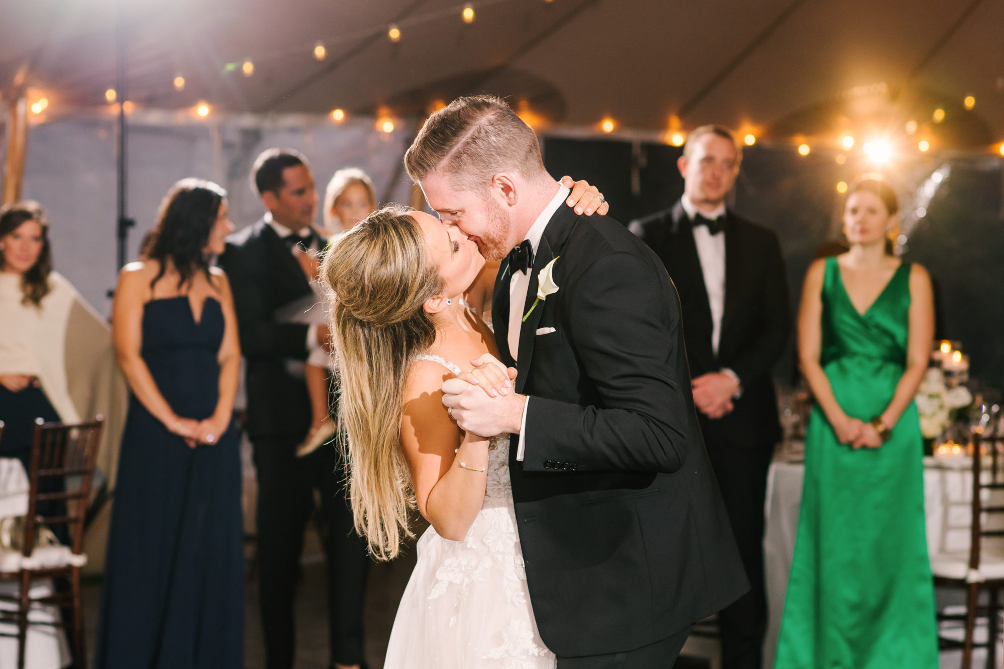 Wedding Photography Tips: How to Take Gorgeous Indoor Wedding Photos by popular New England photographer, Shannon Shipman: image of a bride and groom kissing on the dance floor. 