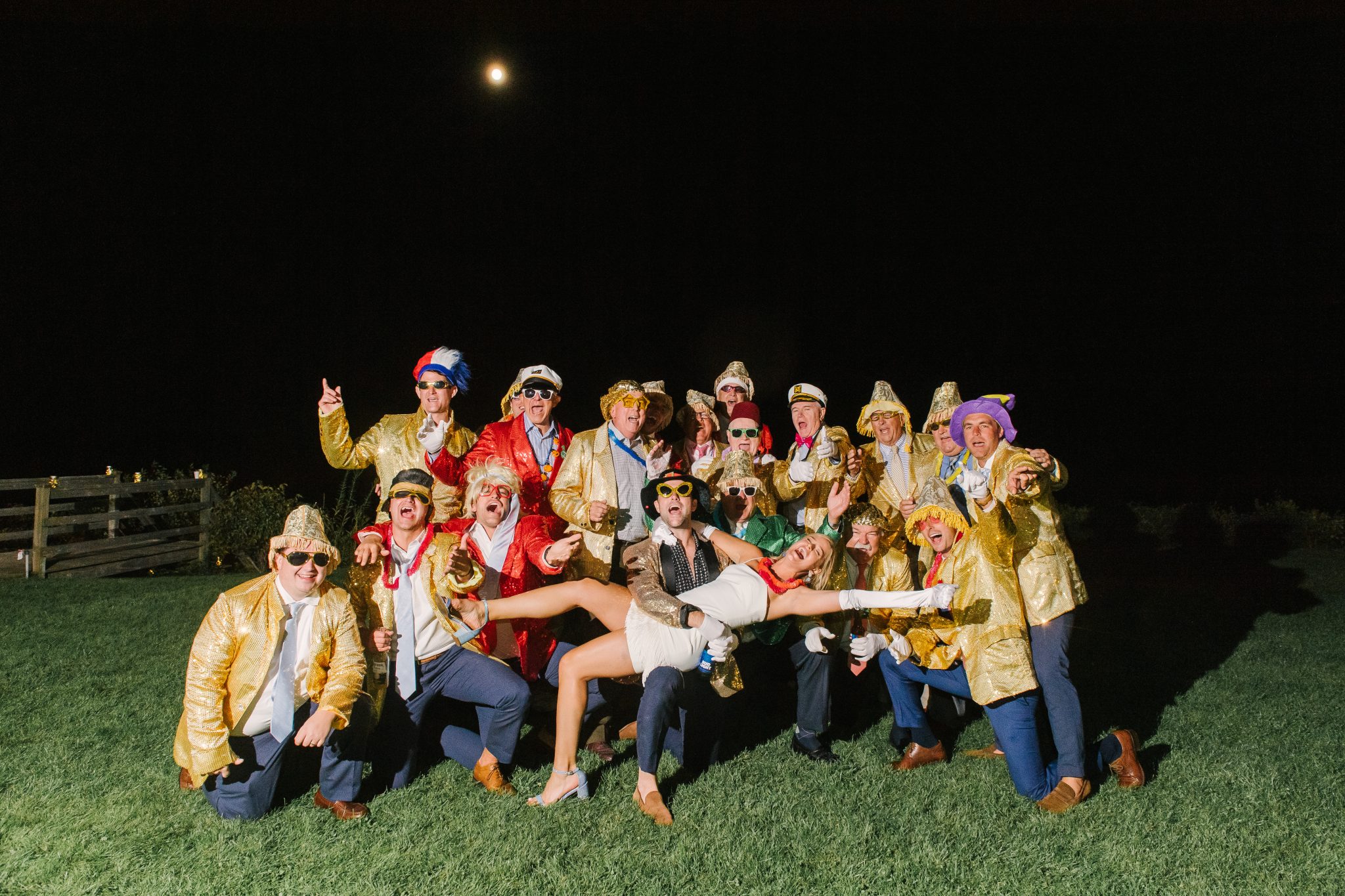 Wedding Photography Tips: How to Take Gorgeous Indoor Wedding Photos by popular New England photographer, Shannon Shipman: image of a a group of people dressed in silly costumes and standing together as a group. 