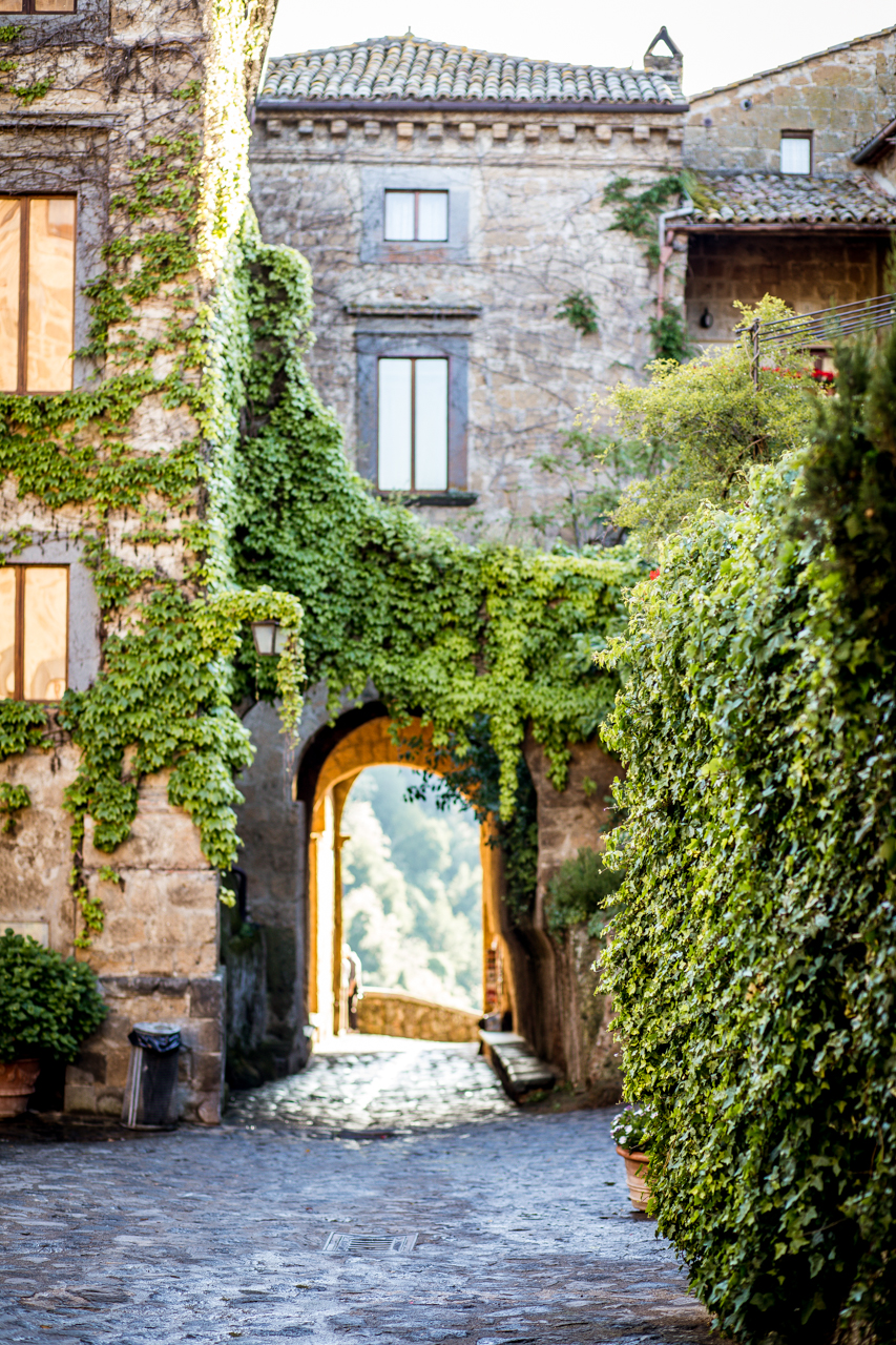 10 Gorgeous Views in Tuscany Italy | Tuscany Photos by popular New England travel blogger, Shannon Shipman: image of a stone villa covered in ivy in Tuscany, Italy. 