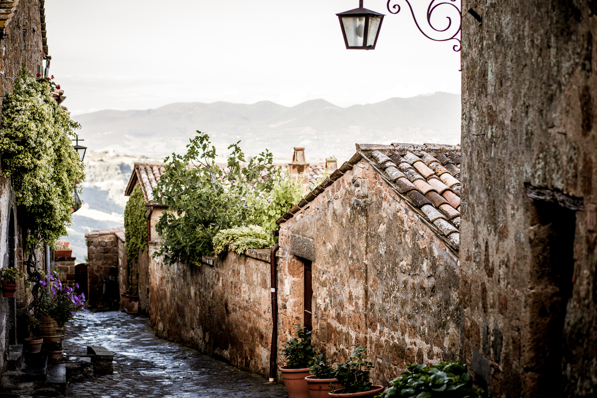 10 Gorgeous Views in Tuscany Italy | Tuscany Photos by popular New England travel blogger, Shannon Shipman: image of a stone building with a clay tile roof in Tuscany, Italy. 