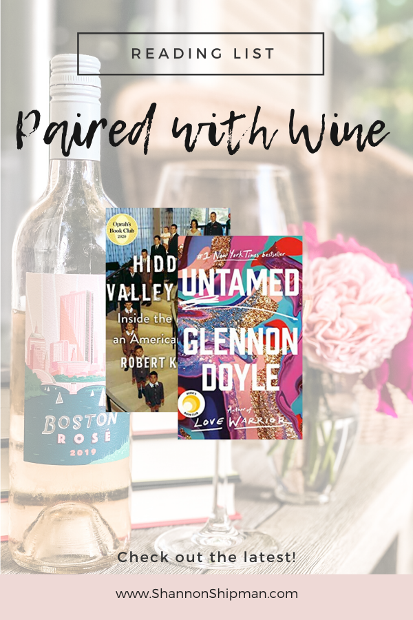 May Reading List by popular New England lifestyle blogger, Shannon Shipman: Pinterest image of a bottle of rose next to a vase of pink flowers and a stack of books. 